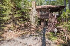 a cabin in the woods surrounded by trees