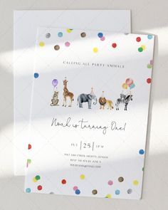 an animal themed birthday party is set up on top of a white card with confetti