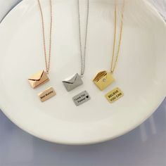 Put your personal message into this special envelope-shaped necklace to wear on your neck or to gift it. Customize your message and our jewelers will engrave it on the inner “note” of a letter. You can use numbers, capital and small letters of the English alphabet (Latin-script alphabet) but it should not exceed 48 characters including spaces. Description: Pendant size: 20 x 14mm / 0.8 х 0.55” Material: Titanium steel. Lead-free and nickel free, hypoallergenic necklace has no irritation for sens Sterling Silver Minimalist Locket Necklace As Gift, Minimalist Sterling Silver Locket Necklace Gift, Initial Pendant Locket Necklace With Chain As Gift, Gift Charm Necklace With Nameplate, Minimalist Locket Charm Necklace For Gifts, Elegant Engraved Charm Necklace For Best Friend, Envelope Shaped Necklace For Mother's Day Gift, Minimalist Personalized Locket Necklace As Gift, Elegant Necklaces For Anniversary Gift With Message Card