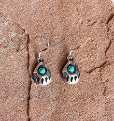 "Vibrant, Southwestern, and versatile dangle earrings that are handcrafted by me! These earrings are comfortable and lightweight, making it ideal for everyday wear. They add a pop of color and a Southwestern vibe. It would be a beautiful addition to your outfit! The stone is American Turquoise. All findings are 925 sterling silver. Measurements: 1\" long and a 10x13mm sterling silver bear paw with 2mm turquoise stone in the center. The earrings are dangle earrings with an ear wire. Handcrafted i Handmade Southwestern Dangle Teardrop Earrings, Handmade Southwestern Teardrop Dangle Earrings, Southwestern Adjustable Teardrop Earrings, Adjustable Southwestern Teardrop Earrings, Adjustable Southwestern Style Teardrop Earrings, Handmade Southwestern Turquoise Teardrop Earrings, Southwestern Turquoise Teardrop Earrings For Gift, Handmade Turquoise Teardrop Earrings Southwestern Style, Turquoise Nickel-free Southwestern Teardrop Earrings