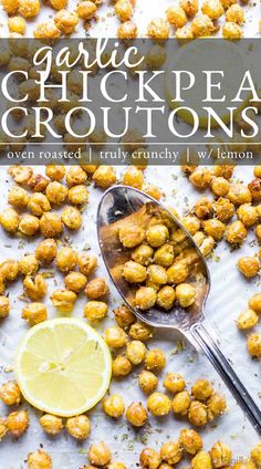 garlic chickpea croutons on a baking sheet with a lemon wedge and spoon