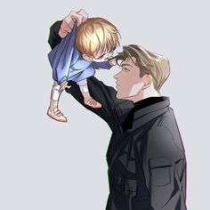 a man holding a child up to his face while another person holds him in the air