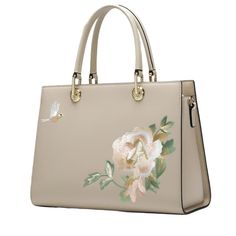 Introducing the enchanting Carolina Women's Embroidered Cowhide Bag, where beauty meets practicality. Crafted from luxurious cow split leather, this portable bag features a stunning floral embroidered design that beautifully complements its solid color palette. Available in apricot, off-white, and sky blue, this square-shaped bag measures 11.8" x 9" with a depth of 4.7", making it perfect for everyday elegance. The zipper closure ensures your belongings stay secure, while the internal zippered pouch and side pocket offer organized storage. Carry it by the short handles or wear it with the long shoulder strap for versatile, enchanting style. Rectangular Leather Bag With Floral Embroidery, Leather Bag With Floral Embroidery And Rectangular Shape, Embroidered Top Handle Shoulder Bag, Ladies' Floral Embroidery Top Handle Bag, Elegant Spring Satchel Bag, Elegant Satchel Bag For Spring, Formal Embroidered Top Handle Shoulder Bag, Elegant Large Capacity Satchel For Spring, Chic Embroidered Top Handle Bag