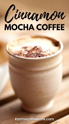 a close up of a cup of coffee on a table with the words cinnamon mocha coffee