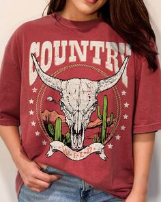 "Western Style T-shirt, Country Girl® Desert Scene Tee, Country Wild Comfort Colors Garment Dyed Shirt, Mountains, Cactus, Lasso, Bull Skull * Relaxed fit * Neckline: Crewneck * Sleeve length: Short sleeve Handmade in our shop with high quality retail printing on a quality garment dyed 6.1 oz. 100% preshrunk ring spun Comfort Colors cotton t-shirt. Care Instructions Wash in cold/warm water and tumble dry with low heat turning the shirt inside out. Do not iron. Sizing (Unisex) Body Length - Measured from the highest part of the shoulder to the bottom hem. (SM-26.6\", MD-28\", LG-29.4\", XL-30.75\", 2X-31.6\", 3X-32.5\", 4X-33.5\") Body Width - Measured from side seem to side seem just below the sleeve. (SM-18.25\", MD-20.25\", LG-22\", XL-24\", 2X-26\", 3X-27.75\", 4X-29.75\") Processing & Casual Acid Wash T-shirt With Skull Print, Acid Wash Skull Print Crew Neck Top, Bohemian Distressed Short Sleeve T-shirt, Acid Wash Graphic Tee With Skull Print, Acid Wash Skull Print Graphic Tee, Girls Clothing Stores, Desert Scene, Country Girls Outfits, Bull Skull