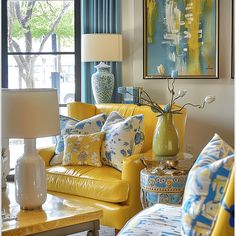 a living room with yellow furniture and blue curtains