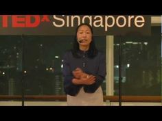 a woman standing in front of a sign with the words teda singapore on it