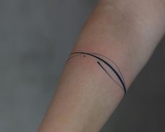 a person's arm with a small tattoo on the left side of their arm