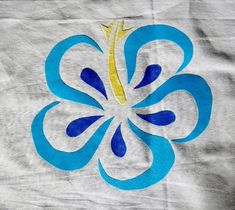 a blue and yellow flower on a white cloth