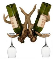 two wine bottles are attached to an antler