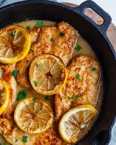 chicken with lemons and parsley in a skillet