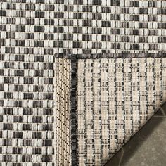 an area rug with black and white squares on it