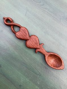 a wooden spoon with two hearts on it