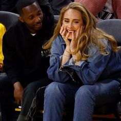 a woman sitting next to a man at a basketball game