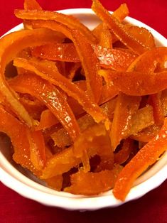 a white bowl filled with sliced orange peels