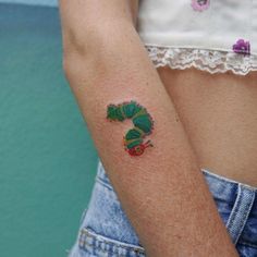 a person with a small tattoo on their arm and the image of a caterpillar