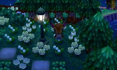 an animal is standing in the middle of a garden with flowers and trees at night