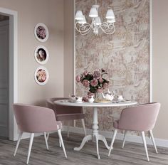 a dining room with pink chairs and a white table