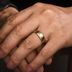 two hands holding each other while wearing wedding rings