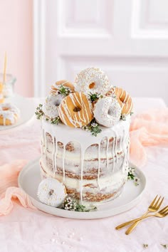 a white cake with frosting and donuts on top