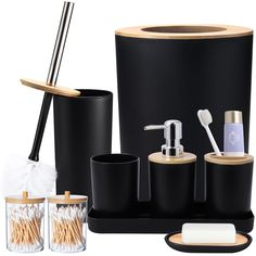 black bathroom accessories including soap dispenser, toothbrush holder and cup with bamboo lid