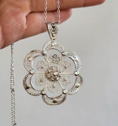 Ornate White Gold Pendant Necklace, White Gold Necklace With Large Flower Pendant, Luxury White Gold Necklace With Large Flower Pendant, Silver Engraved Flower Pendant Necklace, Delicate Pendant Jewelry With Intricate Design, White Ornate Filigree Necklace, Ornate White Filigree Necklace, Vintage Silver Flower-shaped Necklace, Vintage Silver Flower Pendant Necklace