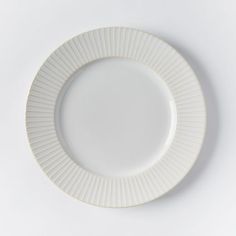 an empty white plate on a white surface