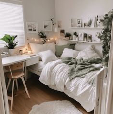 a white bed sitting next to a desk in a room with lots of lights on it