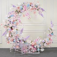 an arrangement of flowers arranged around a chair