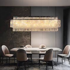 a dining room table with chairs and a chandelier hanging from it's ceiling