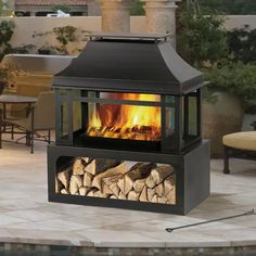 an outdoor fireplace with logs in it