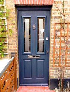 a blue front door on a brick building