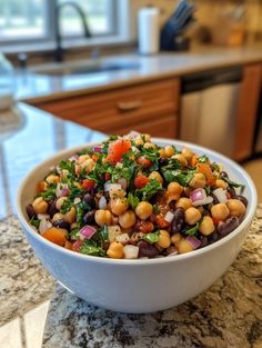 a white bowl filled with vegetables on top of a counter