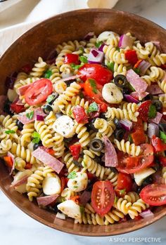 a bowl filled with pasta salad on top of a table