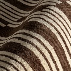 a close up view of a zebra print fabric with brown and white stripes on it