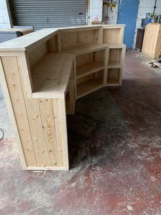 an unfinished wooden desk in a garage