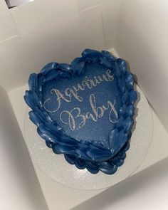 a blue heart shaped cake in a white box