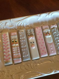 an assortment of cell phone cases sitting on top of a white tray with pink and green designs