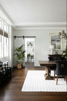 a living room filled with furniture and plants