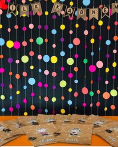 a table topped with lots of brown paper bags filled with confetti and streamers