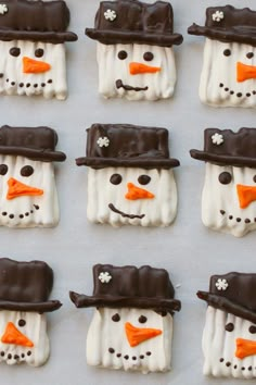 frosted snowmen with hats and noses are arranged in rows