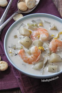 a bowl of soup with shrimp and dumplings in it on a purple table cloth