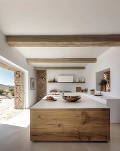 a kitchen with an island counter and wooden beams