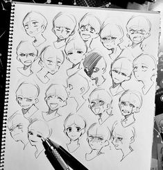 a pencil drawing of various facial expressions on a piece of paper with some pens next to it