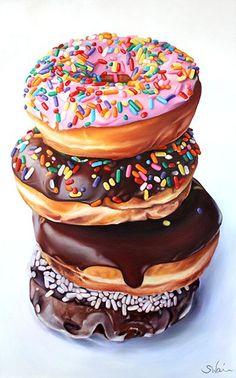 three donuts with chocolate and sprinkles are stacked on top of each other