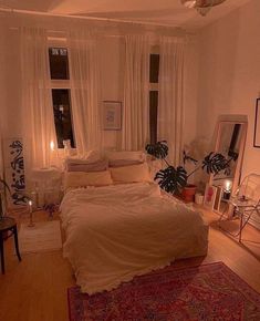 a bed room with a neatly made bed next to two windows and a rug on the floor