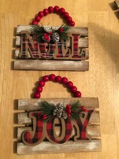 two wooden signs that say noel and joy