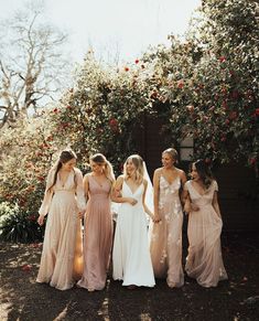 the bridesmaids are all dressed in different colors and styles for their wedding day