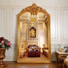 a living room with a large gold mirror