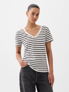 Made with 100% organically grown cotton.  Organic cotton is better for people and the environment because it’s grown without the use of harmful synthetic pesticides and fertilizers.  Short sleeves.  V-neck.  Straight silhouette with a relaxed fit.  Hits at the hip.  Nissa is 5’9. 5”/177cm with a 31”/79cm chest, 24”/61cm waist, 35”/89cm hip wearing a regular Gap Organic Cotton Summer Tops, Summer Organic Cotton Tops, Gap T-shirt For Everyday Spring Wear, Gap Organic Cotton Short Sleeve Top, Casual Organic Cotton T-shirt By Gap, Casual Gap Organic Cotton T-shirt, Gap Casual Organic Cotton T-shirt, Gap Relaxed Fit T-shirt For Spring, White Everyday Gap Tops